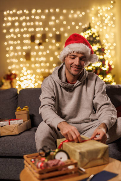 istock Man enjoying Christmas in cozy living room setting 2178866268
