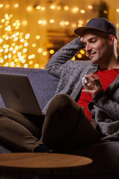 Man enjoying Christmas ambiance while using laptop