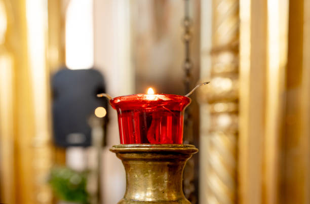 Candle On Blurred Background Of Catholic Church Creates Serene Atmosphere