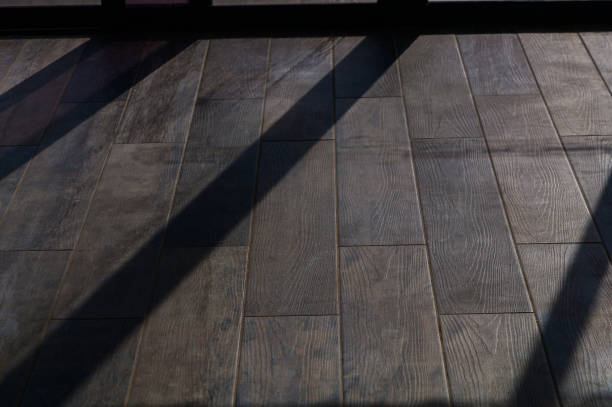 istock Sunlight Streaming Through a Window Casts Patterned Shadows on Polished Wooden Flooring in a Serene Indoor Setting 2178868256