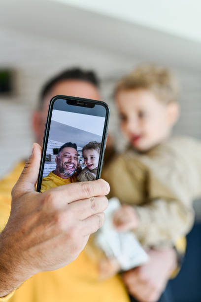 istock Father and Son Bonding While Taking Cute Selfies on Telephone Together Smiling and Having Fun 2178871445