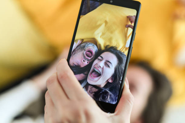 istock Beautiful Joyful Couple Having Fun Taking Selfies While Shouting and Playing With Each Other's Hair 2178871727