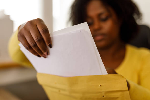 istock Businesswoman packing documents from a yellow envelope 2178873094