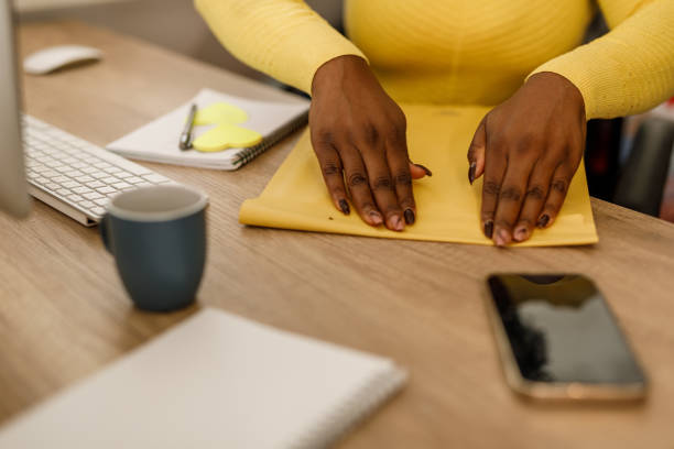 istock Young businesswoman sealing a yellow envelope after packing a document inside 2178873146