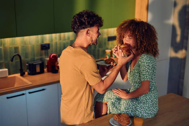 istock Happy Couple Enjoying Breakfast Together in Modern Kitchen 2178877366