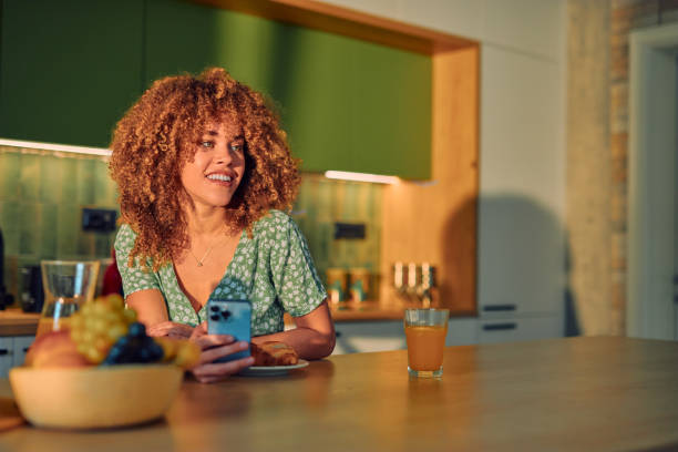 istock Woman Enjoying Technology in a Modern Kitchen Setting 2178877538