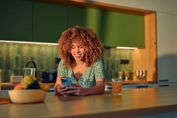 istock Woman Enjoying Technology in a Modern Kitchen Setting 2178877540