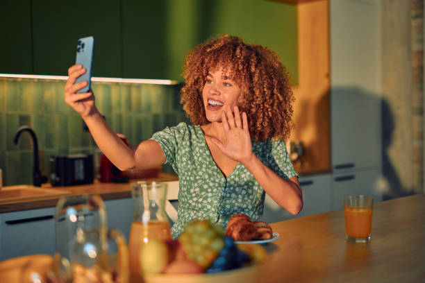 istock Joyful Woman Video Calling While Enjoying Breakfast At Home 2178877616