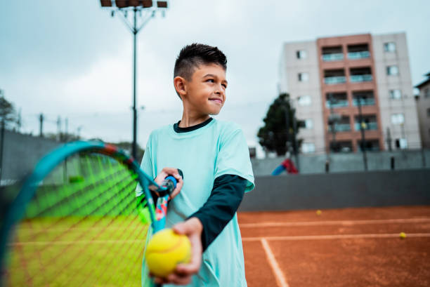 istock Boy serving on a tennis court 2178882037
