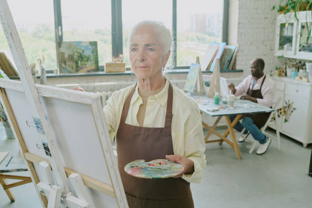 istock Elderly Woman Painting on Canvas 2178886049