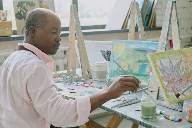 istock Elderly Man Wetting Paintbrush 2178886820