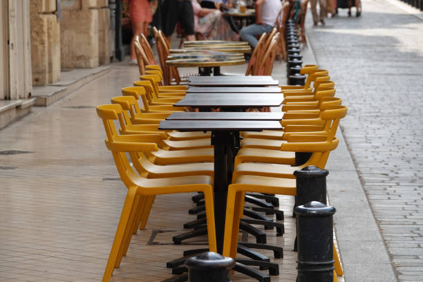 istock empty tables and chairs on the city streets waiting for restaurant customers 2178889074
