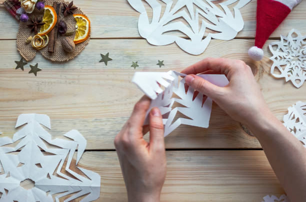 istock A snowflake made from paper with your own hands gracefully decorates a winter interior, adding warmth and a cozy atmosphere 2178889308