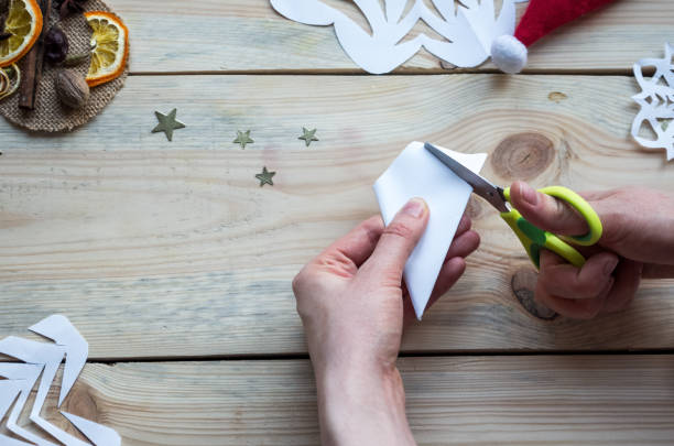 istock A snowflake made from paper with your own hands gracefully decorates a winter interior, adding warmth and a cozy atmosphere 2178891999