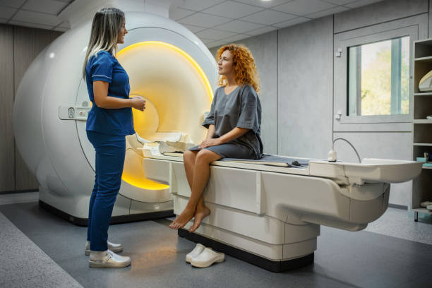 Medical Technician Prepares the Patient for the MRI.