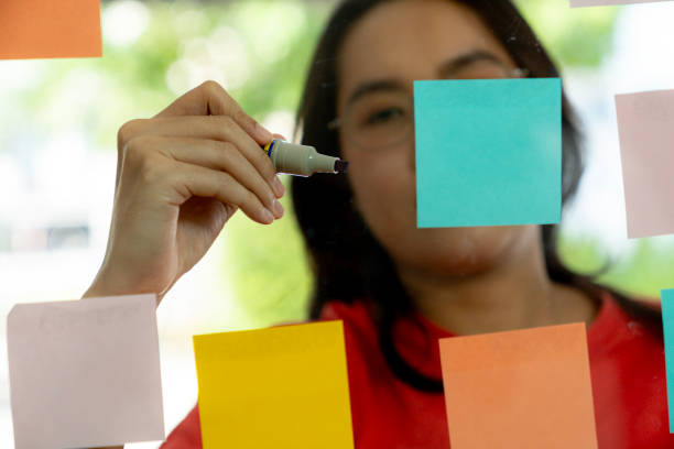 istock A young businesswoman is writing business ideas on a sticky note 2178906568