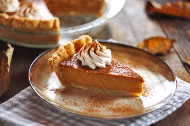 istock Traditional pumpkin pie topped with whipped cream. Selective focus. 2178907849