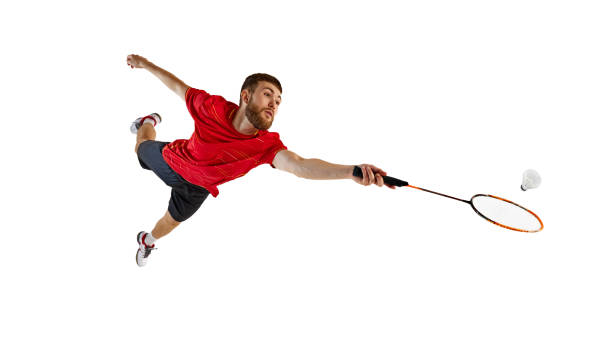 istock Badminton player in full flight, jumping high with racket poised for winning hit. Graceful movement to get win. 2178909631