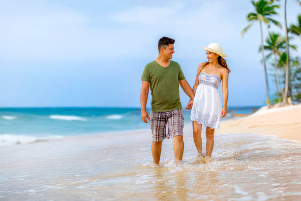 istock Hispanic engaged couple walking along a tropical island beach 2178910081