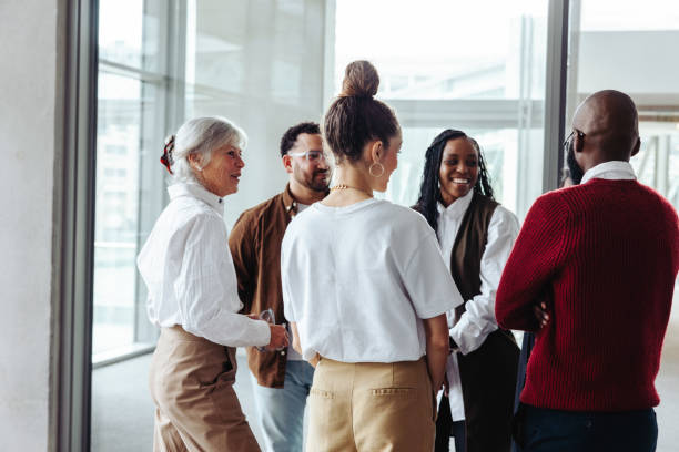 Diverse business colleagues engaging in conversation during a conference in a modern office setting