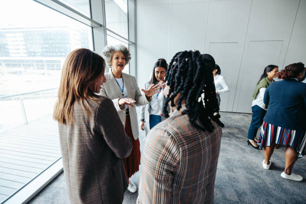 istock Diverse group of business professionals networking and engaging at a corporate event 2178912384
