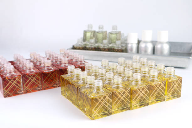 luxury aromatic scent of reed diffuser glass bottle is used as room freshener on white steel table in the bedroom to creat relax ambient with background of light from window and white bed in morning