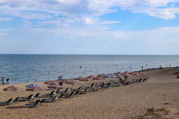 istock Empty sunbeds and umbrellas occupying sandy beach 2178916847