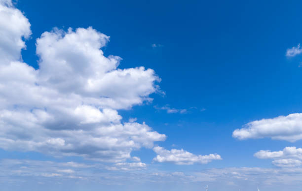 istock Vibrant blue sky adorned with fluffy white clouds, creating a serene backdrop. Perfect for nature lovers and outdoor enthusiasts, capturing the essence of a beautiful day. 2178925574