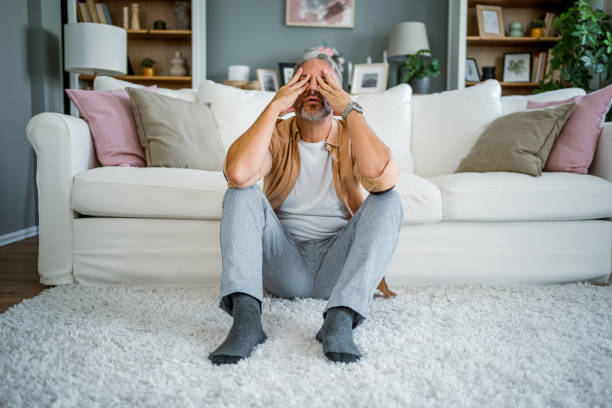 istock Depressed man sitting alone on the floor 2178944020