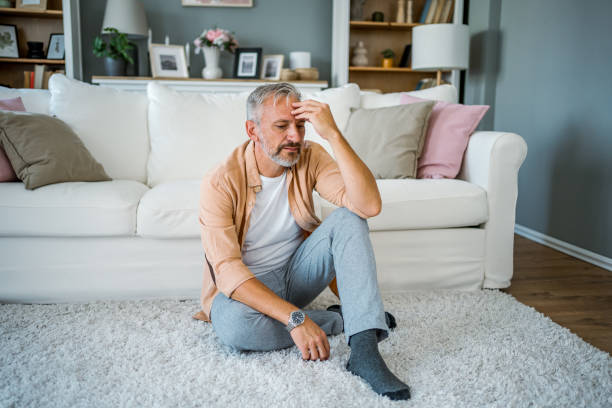 istock Upset man sitting alone in a room 2178944130