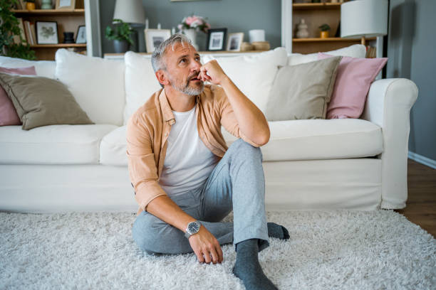istock Upset man sitting alone in a room 2178944210