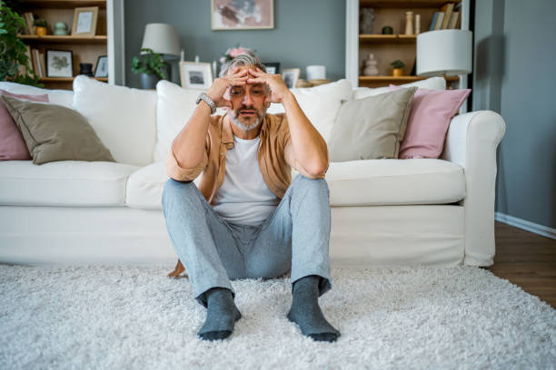 istock Upset man sitting alone in a room 2178944211