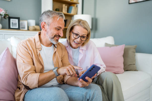 istock Mature couple using smartphone at home 2178945870