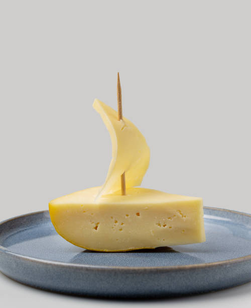 istock boat with a sail made of cheese on a blue plate, copy space 2178946341
