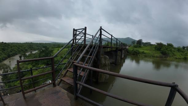 istock Railings provide safety at a small dam under a cloudy sky, ensuring protection for visitors and the surrounding area. 2178950510