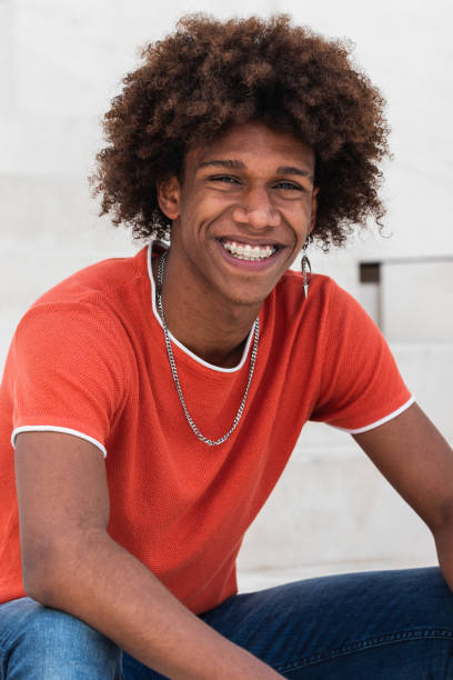 istock Positive young black male smiling at camera while chilling on street 2178952815