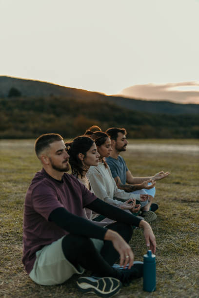 istock Group of people meditating outdoors 2178959215