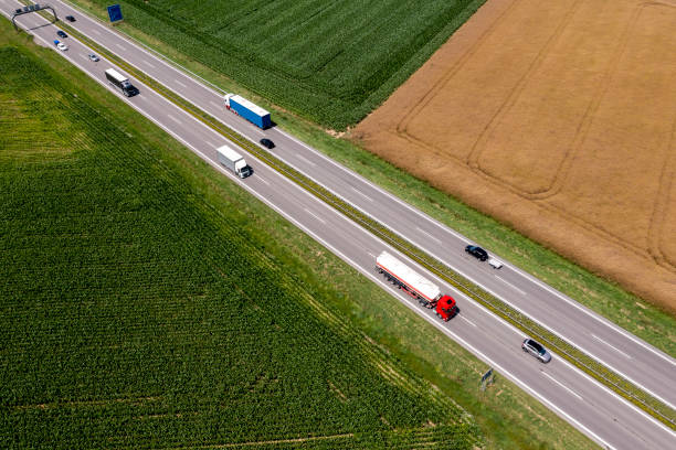 istock Trucks and cars on a highway 2178963750