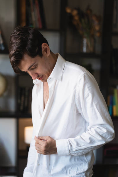 istock The young businessman is buttoning his white shirt. 2178964020