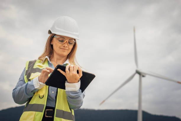 istock A skilled female engineer inspects a wind turbine with her tablet, ensuring efficiency and optimal performance, contributing significantly to sustainability and renewable energy initiatives 2178964496