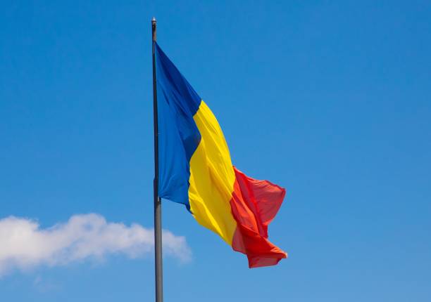 istock Romanian flag waving against a clear blue sky on a sunny day 2178968136