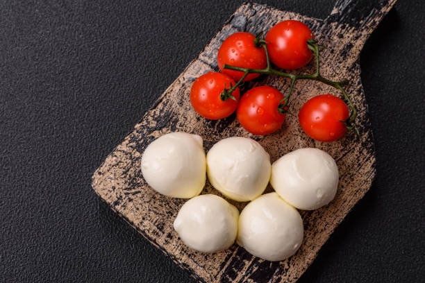 istock Delicious fresh mozzarella cheese with tomatoes, salt and spices 2178970252