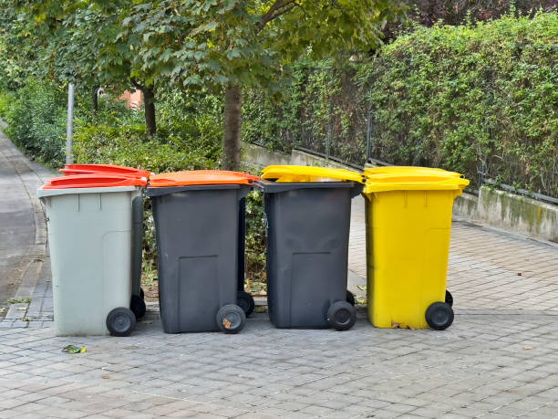 istock Four trash cans are lined up on the sidewalk 2178975491