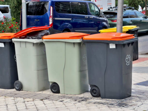 istock A row of trash cans are lined up on the sidewalk 2178975521