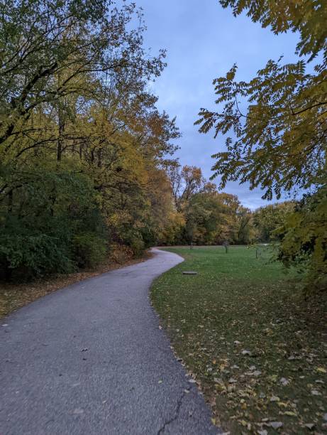 istock Trees start to change in the cooler weather of fall along the multi-use path in Willow Creek Park, Iowa City, IA. 2178982438