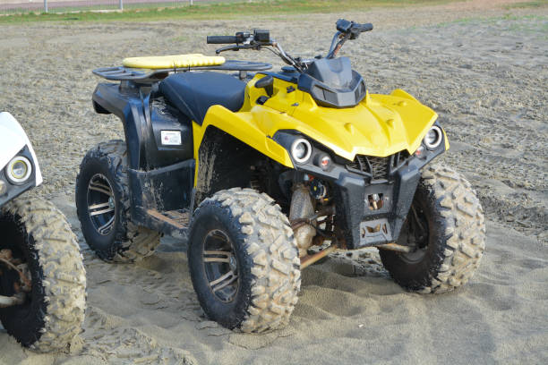 istock Kuantan, Malaysia: October 17th, 2024- The image shows a red and beige ATV parked in a sandy area. 2178983474