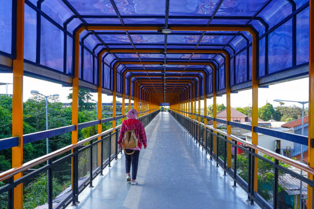 istock a woman crosses a pedestrian bridge 2178986205