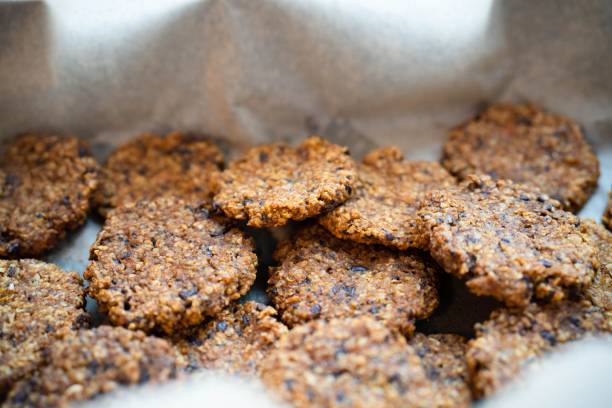 There are oatmeal and chocolate chip cookies on a baking sheet.