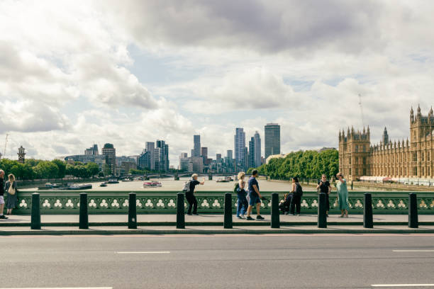 London, England - AUG 03, 2024 - The iconic Houses of Parliament and skyscrapers can be seen in the background