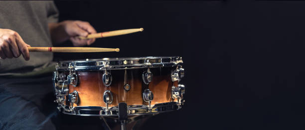 istock A man plays a drum. Drumsticks are hit on the drum. Copy space. 2179002247